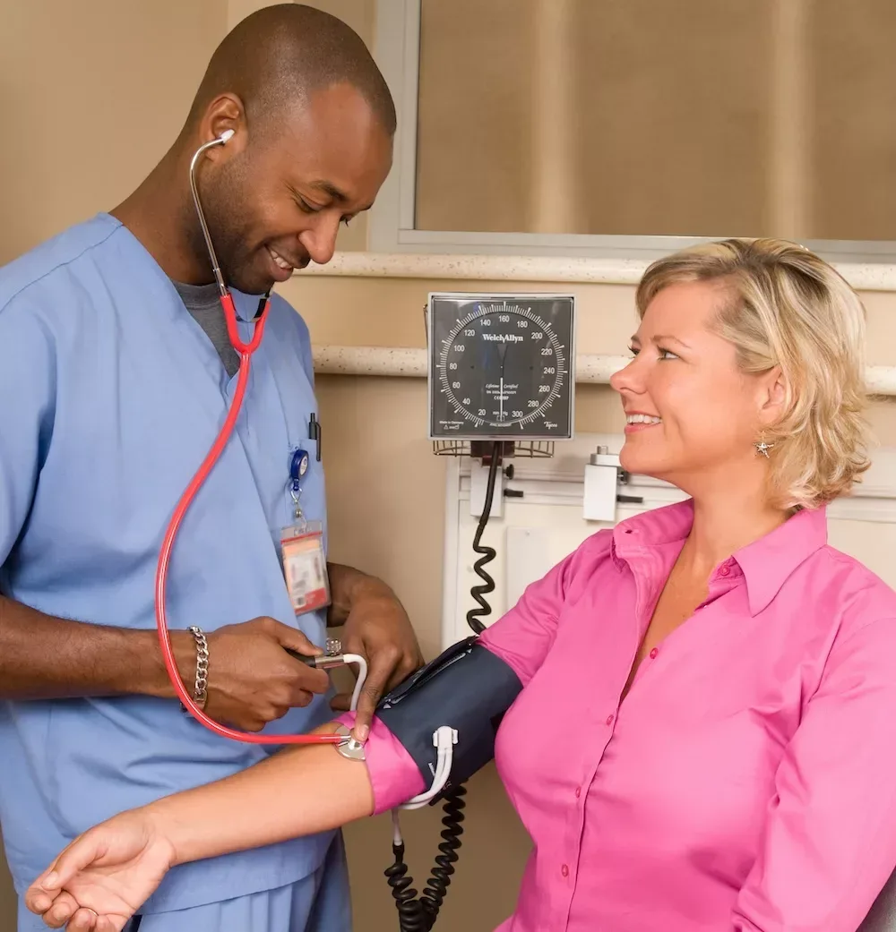 nurse checking patient blood pressure